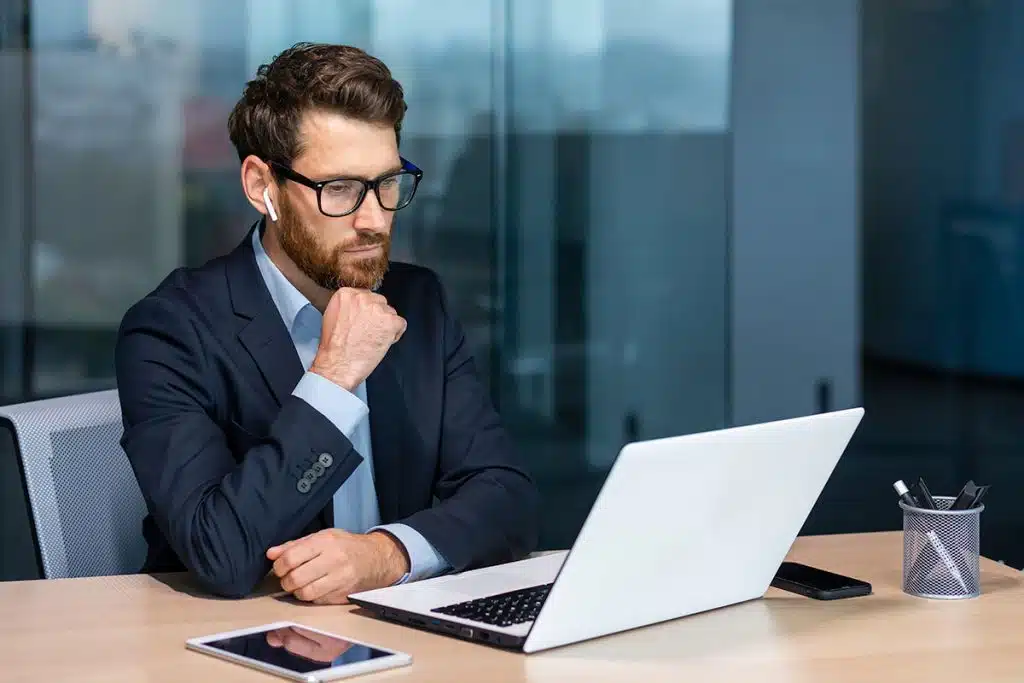 Man thinks while sitting at his computer.